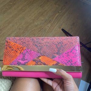 Pink and orange scaled clutch purse from Aldo